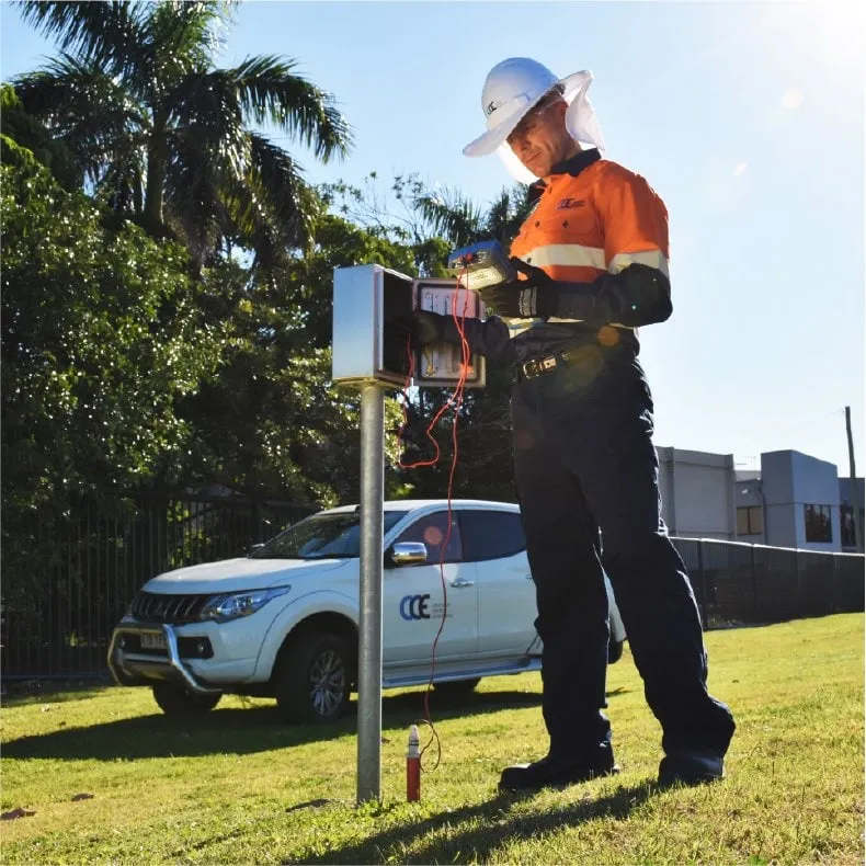 Field operator inspecting the device next to a service vehicle